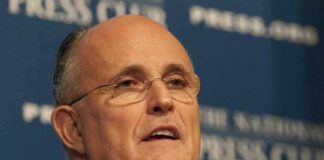 Giuliani Takes Aim At Islam On-Air man in suit speaking at a press event