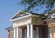 Dirty Word Allegation Rattles Mayor’s Office Exterior view of a city hall building with columns and a clear blue sky
