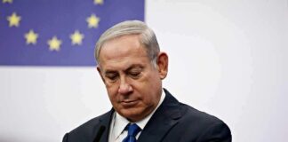 Walkout Drama Shadows Netanyahu man in suit at podium with EU flag in background