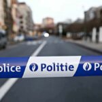 Police tape blocks a city street