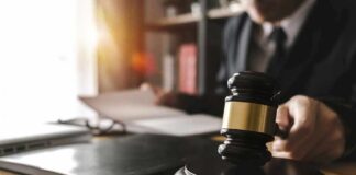 Accused Killer Asks Judge For Immunity Judge's gavel on desk with person reading documents in background