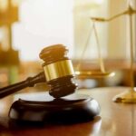Frat House Nightmare Triggers Grand Jury Move Judge's gavel on a block with scales of justice in the background