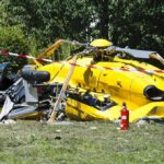 Americans Killed In Remote Helicopter Crash yellow helicopter crash scene on grassy field