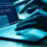 Bank Freeze Starves Grandma Hands typing on a laptop with cybersecurity login overlay