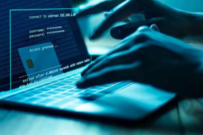 shutterstock_1107463670 Hands typing on a laptop with cybersecurity login overlay