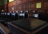 Empty wooden jury box with numbered chairs