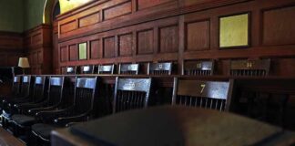 Ohio Court ERUPTS: Escape Bid Turns Brutal Empty wooden jury box with numbered chairs