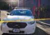 LA Mall Ambush Stuns Shoppers Police car behind yellow caution tape on a city street