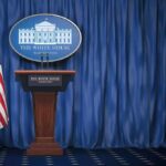 Pump Prices Soar—Industry Summoned to Answer White House press briefing podium with U.S. flag and blue curtain