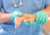Illegal Care Claim Falls Apart Healthcare worker in gloves holding a patient's hand