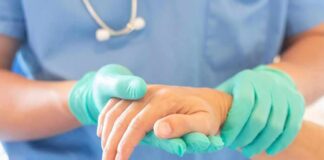 Illegal Care Claim Falls Apart Healthcare worker in gloves holding a patient's hand