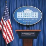 50% Tariff Bomb Hits Canada White House press briefing podium and US flag