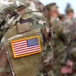 Border Bar Shooting Case Hits Snag U.S. flag patch on a camouflage military uniform
