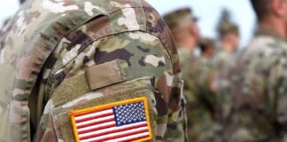 Border Bar Shooting Case Hits Snag U.S. flag patch on a camouflage military uniform