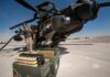 Pentagon Denies U.S. Munitions Shortage attack helicopter on tarmac with crew and ammunition crates