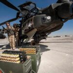Pentagon Denies U.S. Munitions Shortage attack helicopter on tarmac with crew and ammunition crates