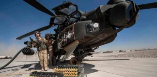 Pentagon Denies U.S. Munitions Shortage attack helicopter on tarmac with crew and ammunition crates