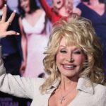 Threats, Extortion Claims Rock Dolly Empire Dolly Parton waving at an event