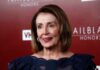 Pelosi’s Latest Stock Disclosure Raises Questions woman in navy lace dress on red carpet