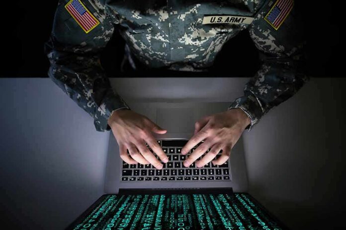 Soldier in camouflage typing on a laptop