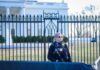 Secret Service Swarm After Sudden Jolt Security officer stands guard outside a large white government building