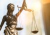 Lady Justice statue holding balanced scales