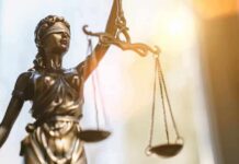 Lady Justice statue holding balanced scales