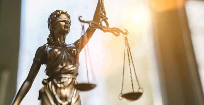 shutterstock_1493152013 Lady Justice statue holding balanced scales