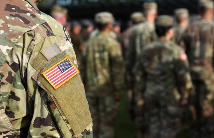 shutterstock_1507034690 Soldier in camouflage with U.S. flag patch at formation