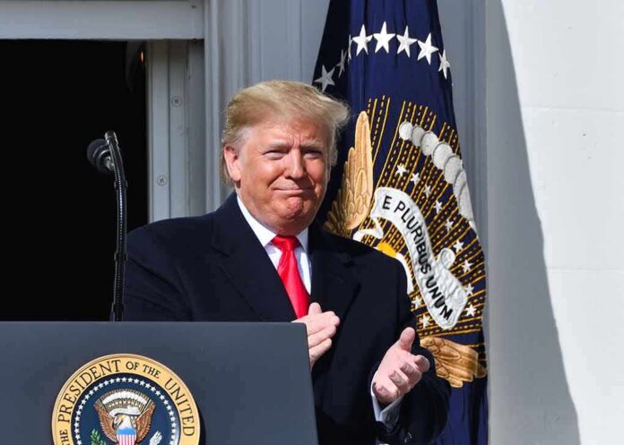 shutterstock_1550249633 man in suit clapping at a podium with presidential seal