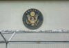 U.S. embassy seal on a building wall