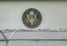 U.S. embassy seal on a building wall