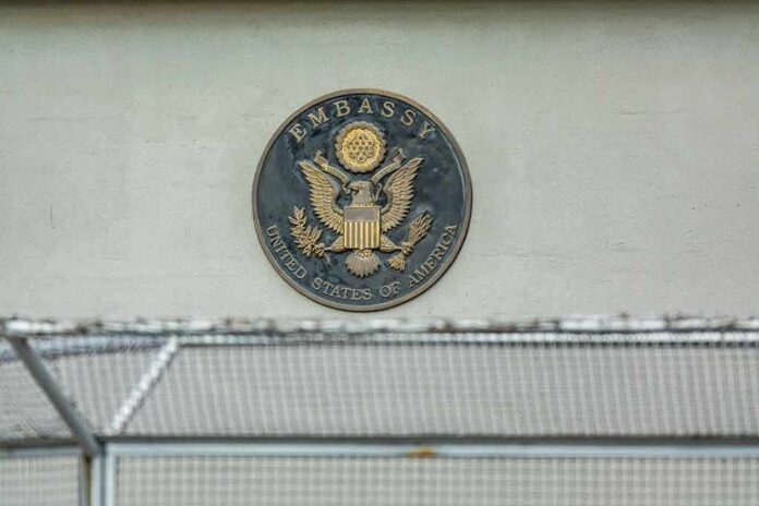 shutterstock_1550491433 U.S. embassy seal on a building wall