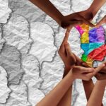 Why Five Major Banks Are Teaming Up Hands forming a heart around a colorful paper silhouette
