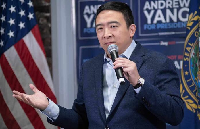 shutterstock_1613108434 Man speaking into a microphone at a campaign event