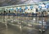 Air Chaos After Mysterious Fiber Cut Airport check-in counters with empty queue barriers