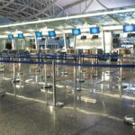 Air Chaos After Mysterious Fiber Cut Airport check-in counters with empty queue barriers