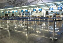 Air Chaos After Mysterious Fiber Cut Airport check-in counters with empty queue barriers