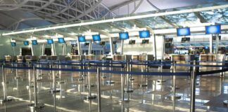 Air Chaos After Mysterious Fiber Cut Airport check-in counters with empty queue barriers