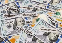 Hundred-dollar bills with cutout words about stimulus and economy