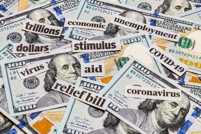 Hundred-dollar bills with cutout words about stimulus and economy