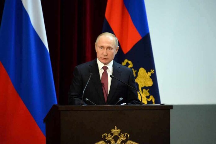 speaker at podium with flags in background