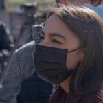Dem Strategists Muzzle AOC woman in black face mask outdoors