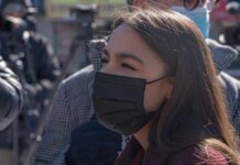 Dem Strategists Muzzle AOC woman in black face mask outdoors