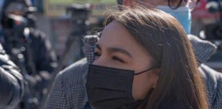 woman in black face mask outdoors