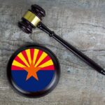 Hobbs Probe Ends With A Surprising Turn Judge's gavel beside a base featuring the Arizona state flag