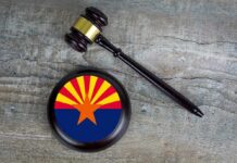 Hobbs Probe Ends With A Surprising Turn Judge's gavel beside a base featuring the Arizona state flag