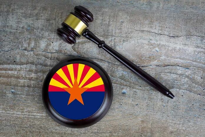 shutterstock_1930820270 Judge's gavel beside a base featuring the Arizona state flag