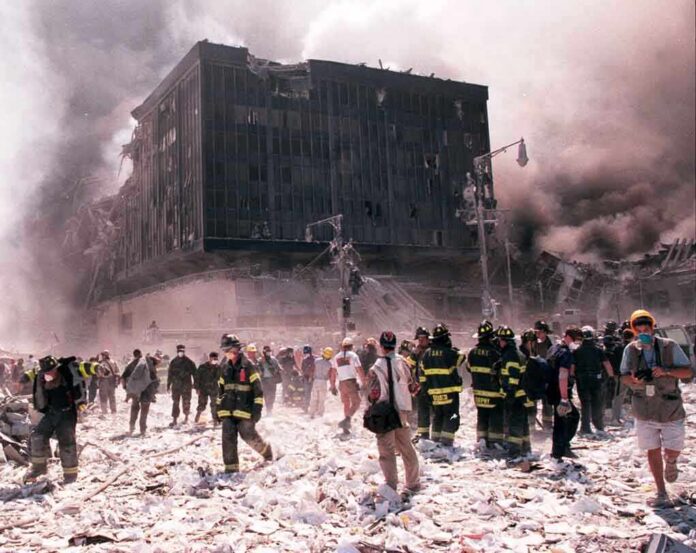 First responders amid debris near a heavily damaged building