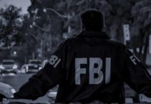 ISIS-Inspired Assault Stopped In Michigan FBI agent in jacket facing a city street at dusk